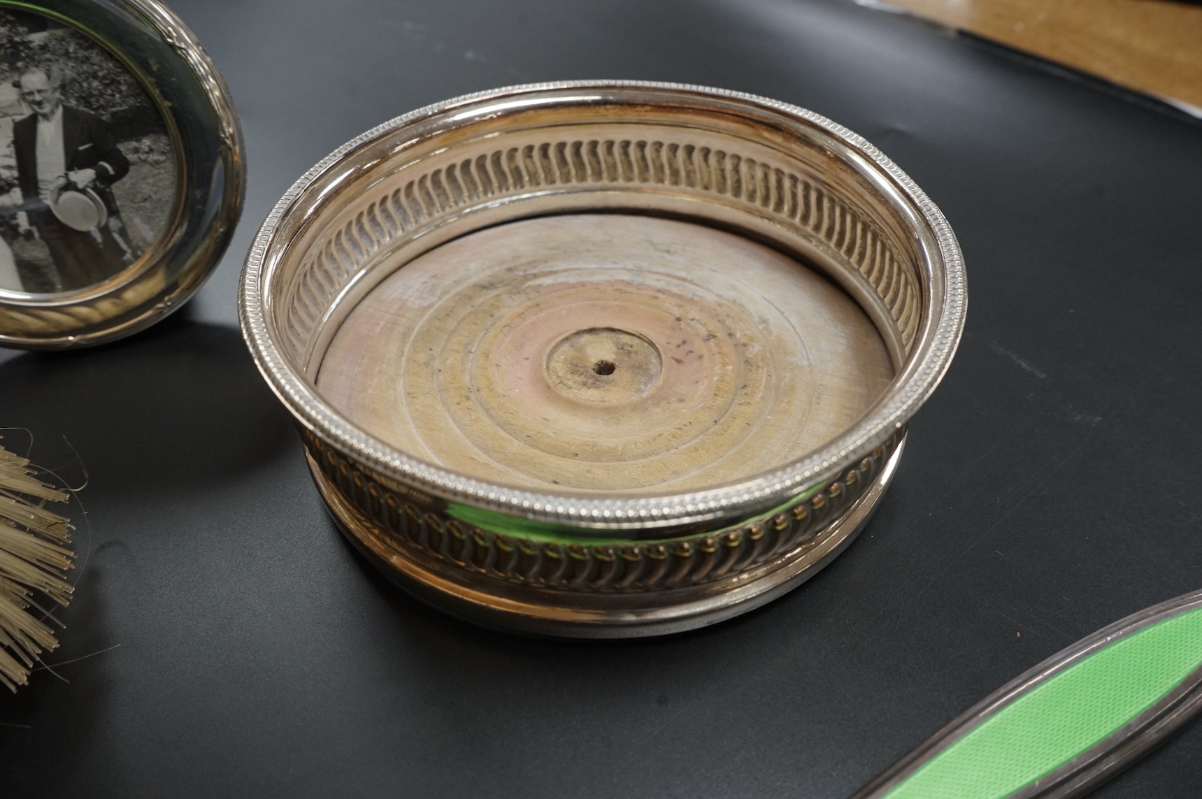 A George V silver rectangular card case by William Henry Sparrow, Birmingham, 1913, 89mm, a modern silver mounted circular photograph frame and five other items including a three piece silver plate and enamel mirror and